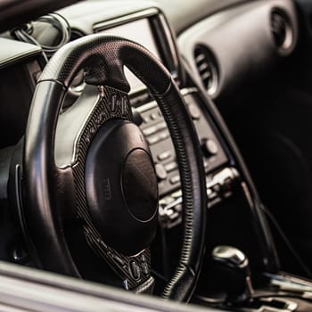 Steering wheel in interior of the sports car