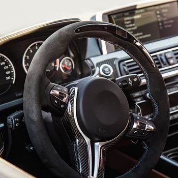 Steering wheel in interior of the sports car