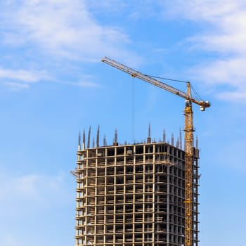 Construction crane on building site on sky background