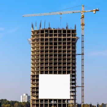 Construction crane on building site on sky background