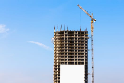 Construction crane on building site on sky background