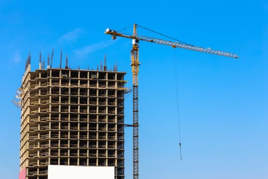 Construction crane on building site on sky background