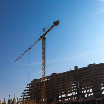 Construction crane on building site on sky background