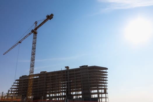 Construction crane on building site on sky background