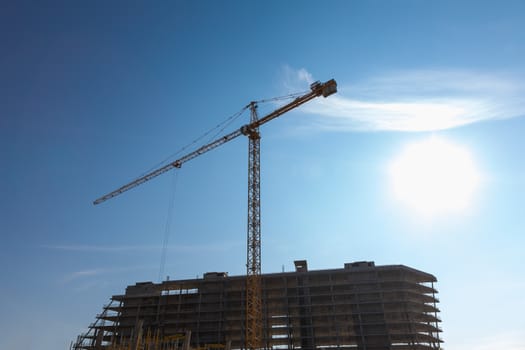 Construction crane on building site on sky background