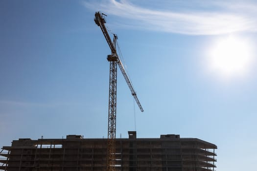 Construction crane on building site on sky background