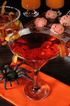 Cocktail with worms in a glass on the table Halloween