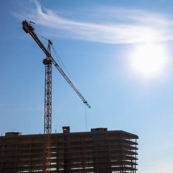 Construction crane on building site on sky background