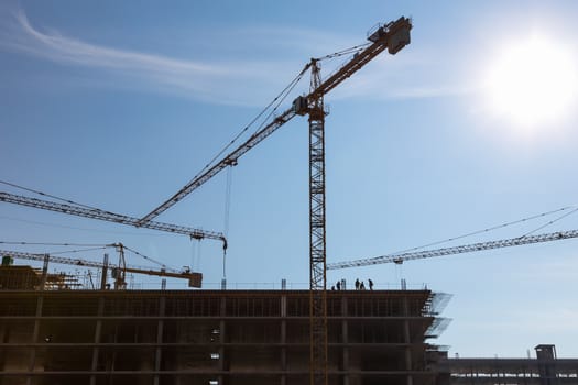 Construction crane on building site on sky background