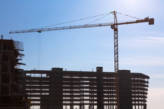 Construction crane on building site on sky background
