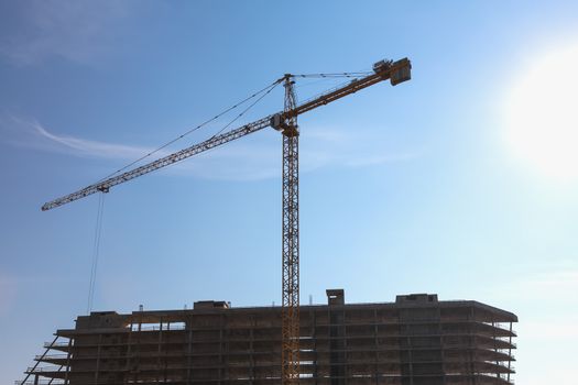 Construction crane on building site on sky background