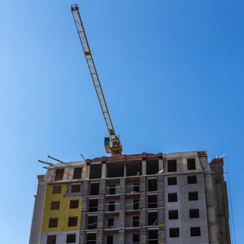 Construction crane on building site on sky background