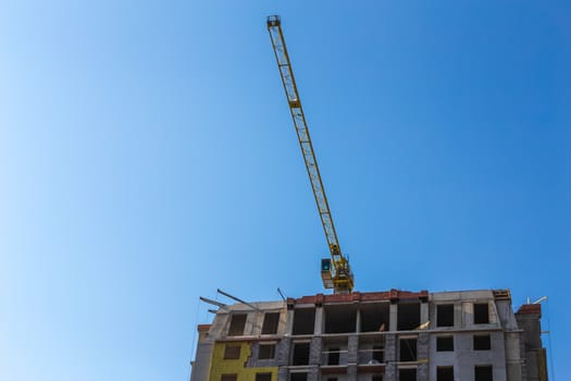 Construction crane on building site on sky background