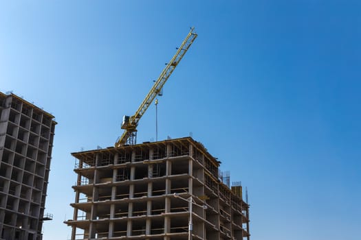 Construction crane on building site on sky background