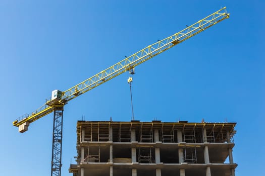 Construction crane on building site on sky background