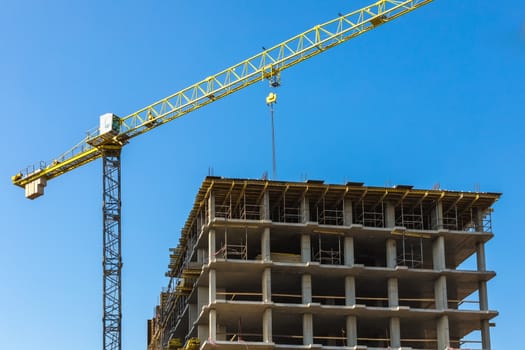 Construction crane on building site on sky background