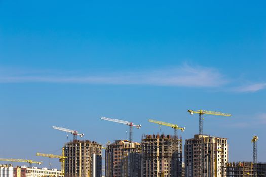 Building cranes on construction of city