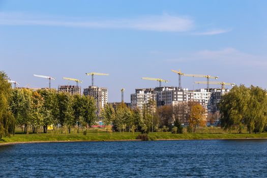 Building cranes on construction of city