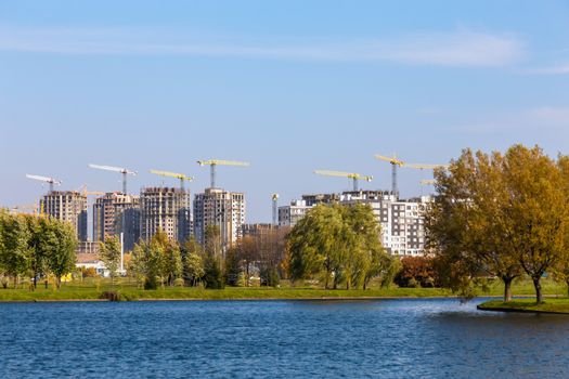 Building cranes on construction of city