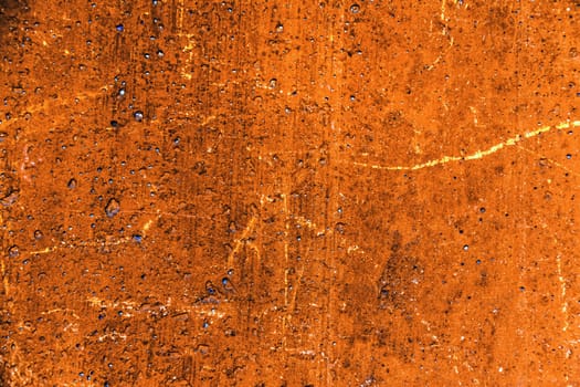 Grunge plaster cement or concrete wall texture orange color with scratches