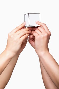 Hands holding white cube on white background