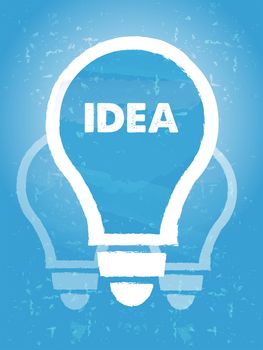 idea in bulb symbol - text and sign over blue grunge background, business creative concept
