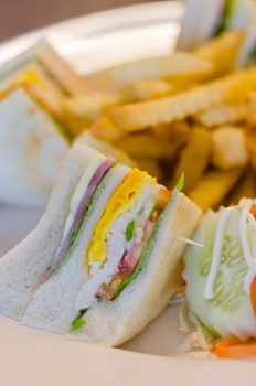 Delicious club sandwich with french fries at a dinner