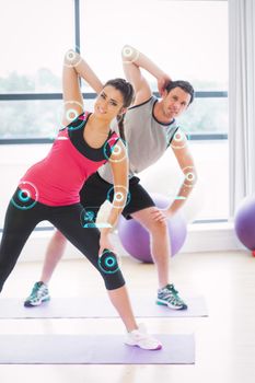 Two people doing power fitness exercise at yoga class against fitness interface