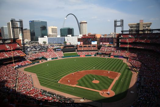 The Gateway Arch towers over a St. Louis Cardinals baseball game at Busch Stadium