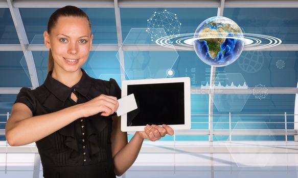 Smiling young woman holging tablet and blank card and looking at camera on abstract blue background with numbers