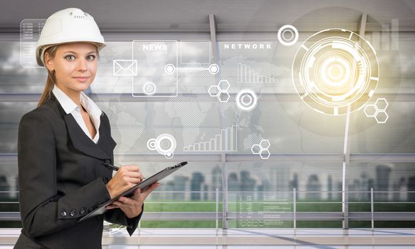 Young woman holding folder in hard hat and looking at camera on abstract digital background
