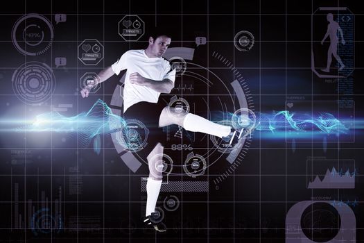 Football player in white kicking against abstract green glowing black background