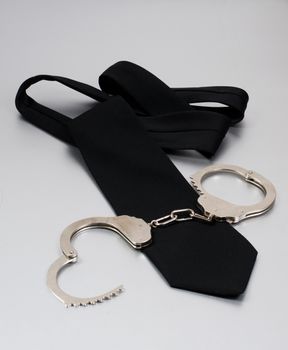 black tie and handcuffs