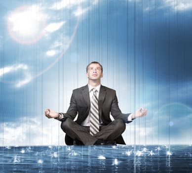 Businessman sitting in lotus position on water and looking up