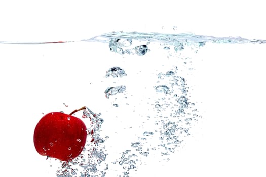 fresh red apple falls deeply under water with a splash isolated on white background