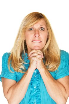 Wishful adult female in blue with folded hands