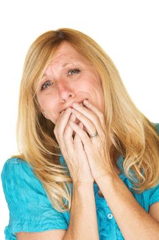 Emotional blond woman in blue with hands over mouth