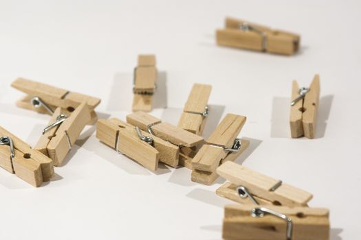 Wooden clothes pegs scattered on a table