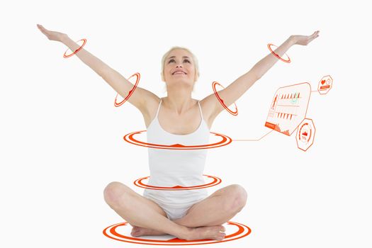 Toned young woman sitting with arms outstretched against fitness interface