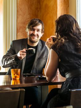 Photo of a young couple sitting in a restaurant on a romantic date.