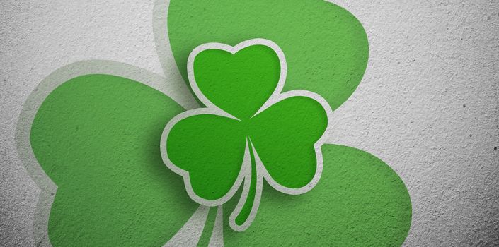 Green shamrock design on grey wall