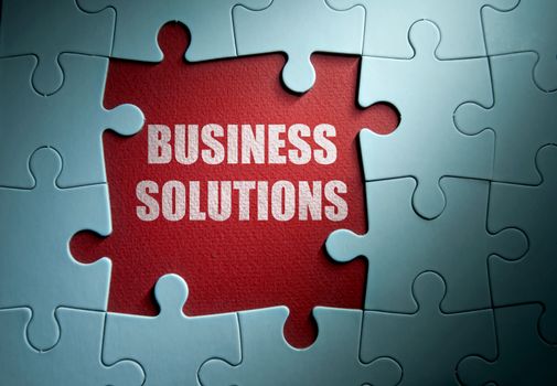 Missing pieces from a jigsaw puzzle revealing business solutions