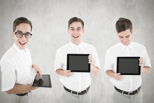 Nerd with tablet pc against white and grey background