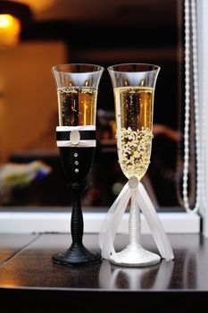 two glasses of champagne on the table.