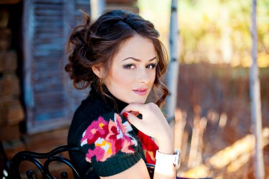 Portrait of a young woman near the wooden wall.