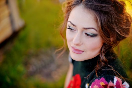 Portrait of a beautiful brunette on natural background.