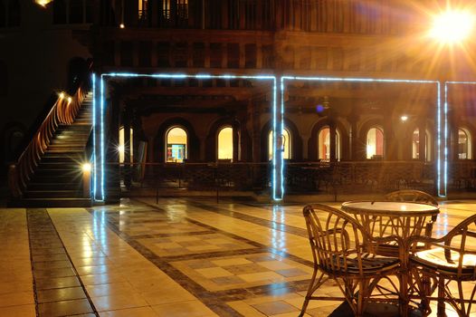 Outdoor evening cafe lit lanterns in summer.