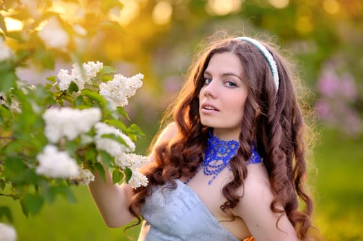 beautiful girl on a background of white flowering trees.