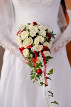 Beautiful wedding bouquet in hands of the bride.