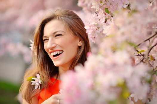 Portrait of smiling face Beautiful brunette woman in spring trees background